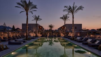 Seasonal outdoor pool, open 9:00 AM to 7:00 PM, pool umbrellas