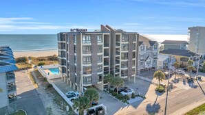 A multi-story hotel with a pool, located near a beach. - 3 bedroom, 3 bath beautiful oceanfront condo on the quiet shore of Cherry Grove. (North Myrtle Beach)