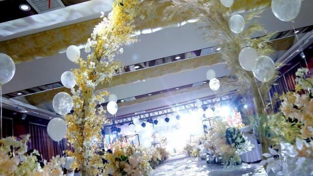 A decorated indoor space with floral arrangements and hanging spherical decorations. - Yunxiang International Hotel (Wuwei)