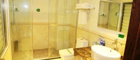 A bathroom with a glass-enclosed shower, a white sink, and a mirror above the sink.