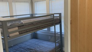 A bunk bed room with a wooden door and windows with blinds. - Two bedroom private home less than 1 block away from the beach (Seaside Park)