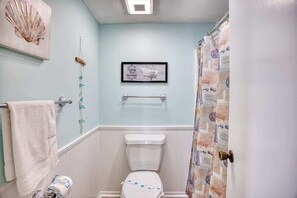 Bathtub, hair dryer, towels, shampoo