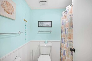 Bathtub, hair dryer, towels, shampoo