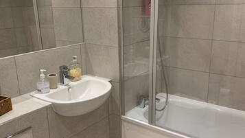 Combined shower/bathtub, hair dryer, towels, toilet paper