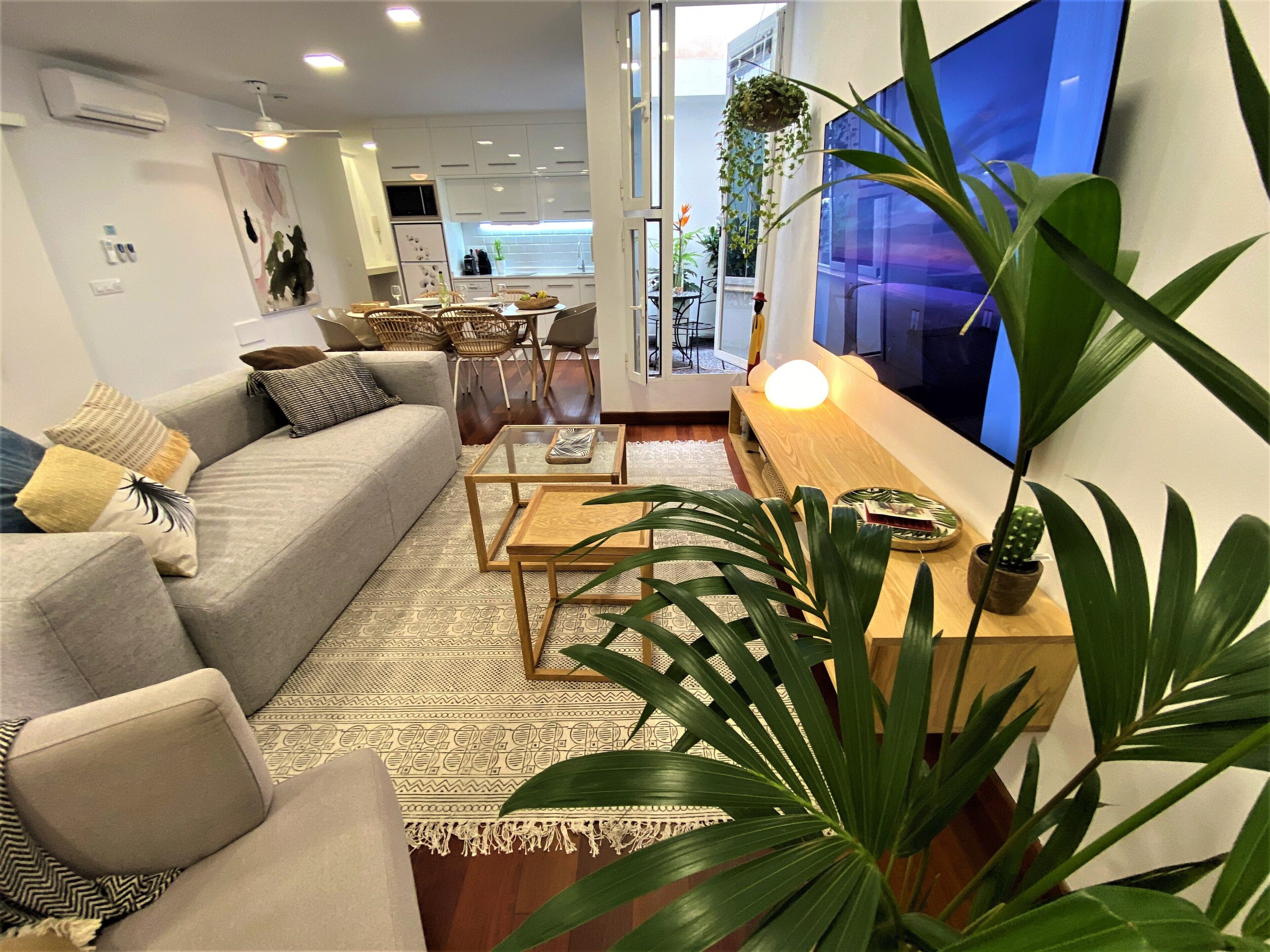 Een moderne woonkamer met een bank, salontafel en televisie.