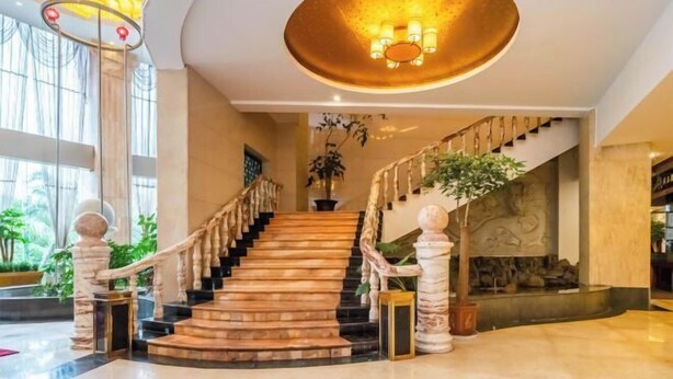 A grand staircase with a marble finish, leading to a lower level. - Shengjing Hotel (Fuyuan)