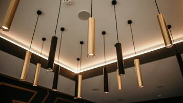 A modern ceiling with multiple hanging pendant lights.