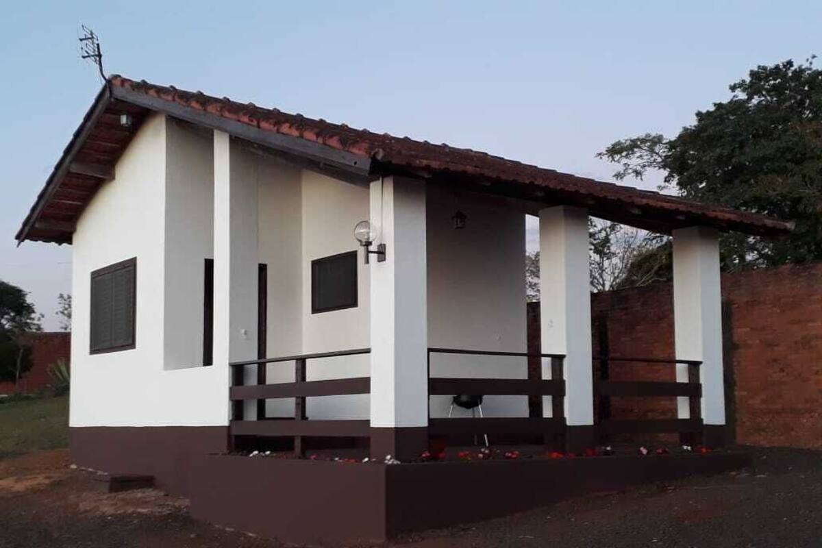 A small, single-story building with a tiled roof and a porch. It has a simple, functional design with a flat roof and a small front porch area.