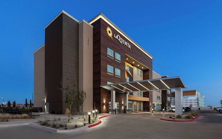 A La Quinta hotel with a modern design, featuring a prominent entrance and a covered walkway.