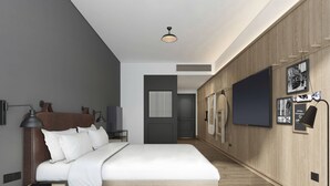 A modern bedroom with a large bed, a bedside table, a desk, and a wardrobe. - Moxy Shanghai Xuhui (Shanghai)