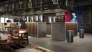 A modern bar area with a neon sign, a bar counter, and a seating area with a patterned rug. - Moxy Shanghai Xuhui (Shanghai)