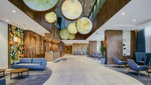 A spacious lobby with a reception desk, seating area, and a modern ceiling design. - Hilton Garden Inn Casablanca Sud (Casablanca)