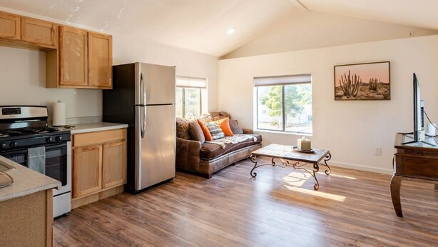 A modern kitchen with wooden cabinets, a stainless steel refrigerator, and a built-in oven. - Perfect, fully furnished 1-bed condo  (Black Canyon City)