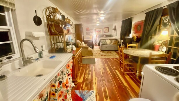 A compact kitchen with a sink, stove, and dining area. - Country Cottage on the farm, peaceful, stars and fireflies! Sleeps 4! (Edmonton)