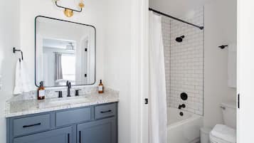 Combined shower/tub, hair dryer, towels, soap