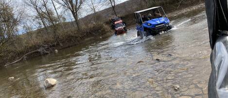 A river with a vehicle crossing it.