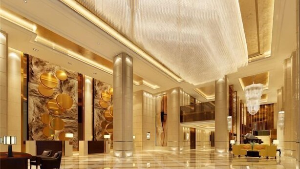 A spacious lobby with a high ceiling, large columns, and a chandelier. - Chenxi International Hotel (Xiapu)