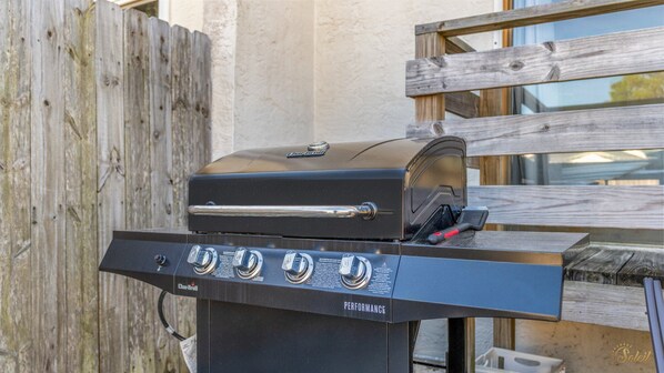 Una parrilla Char-Broil Performance con cuatro perillas de control y un asa.