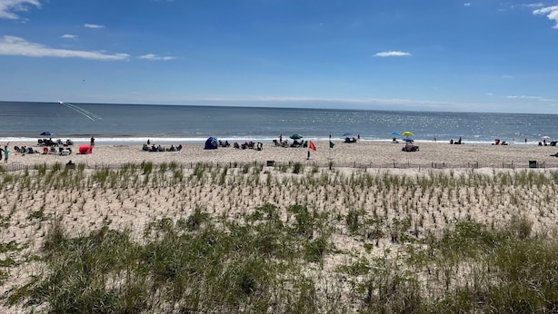 A beach with people, tents, and a flag. - Beach house Davis Park, Fire Island  (brookhaven)
