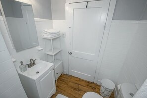 Bathtub, towels, soap, toilet paper