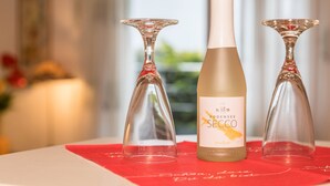 A bottle of Bodensee Secco wine on a table with two empty wine glasses. - Studio Apartment 'B + E Röck' with Private Balcony and Wi-Fi (Meckenbeuren)