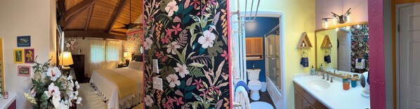 A hotel room with a bed, a bathroom with a sink and toilet, and a hallway with floral wallpaper.