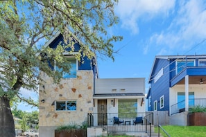A modern two-story building with a stone facade and a blue exterior.