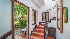 A staircase with a wooden railing leading to a landing. - Quiet Tamarindo 2BR | 10-min Walk to the Beach! (Tamarindo)