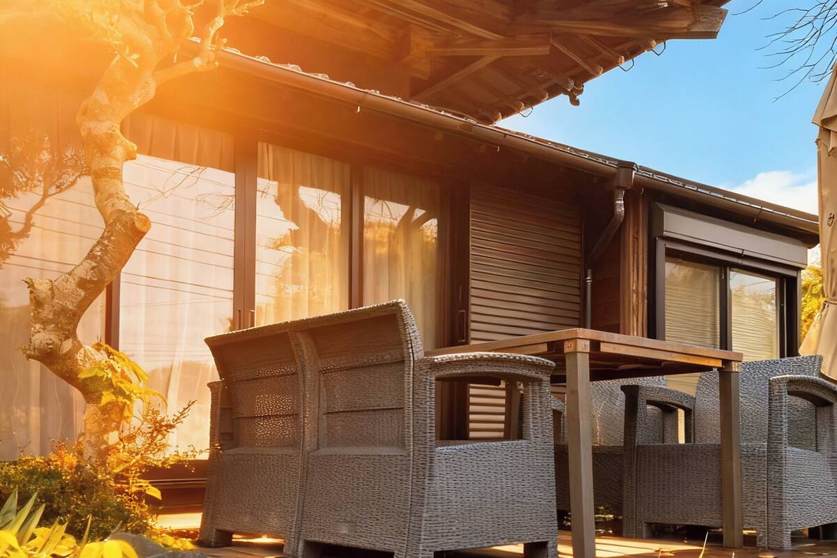 A traditional Japanese-style house with tatami mat flooring, a wooden deck, and a view of the surrounding garden.