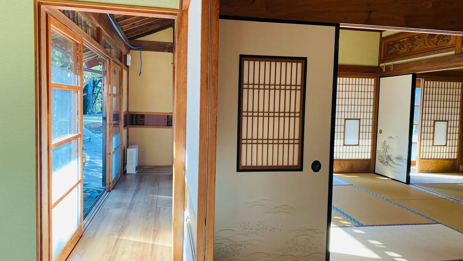 A traditional Japanese room with tatami flooring, sliding doors, and a shoji screen.