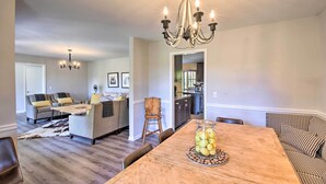 A dining area with a wooden table, a chandelier, and a bowl of lemons. - Mod 'Stable House' on 10 Acres, Walk to Lake! (Oakwood)