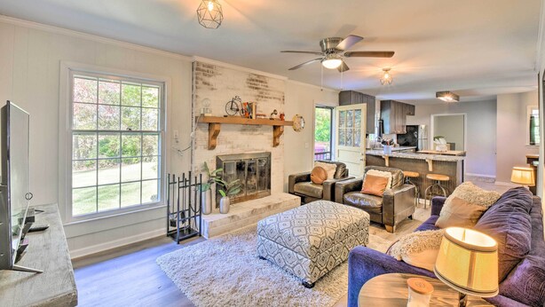 A spacious living room with a fireplace, large windows, and a cozy seating area. - Mod 'Stable House' on 10 Acres, Walk to Lake! (Oakwood)