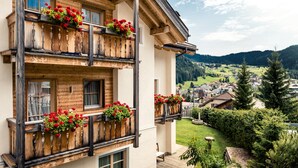Un edificio a più piani con balconi in legno, ognuno decorato con fioriere.