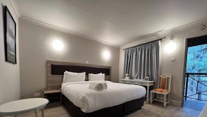 A hotel room with a large bed, bedside tables, a small desk, and a chair. - Kongoni Camp (Nanyuki)