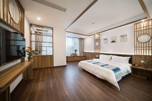 A modern hotel room with a large bed, wooden flooring, a TV, and a view of the city. - Jiu Jian Tang Bo City Hotel (Ningde)
