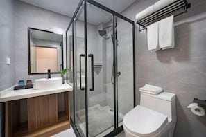 A modern bathroom with a glass-enclosed shower, a white sink, and a toilet. - Jiu Jian Tang Bo City Hotel (Ningde)