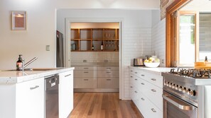 Enjoy cooking in this well-equipped kitchen with a dishwasher, stainless steel range, and large island with sink.