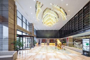 A spacious lobby with a reception desk, a large chandelier, and a seating area. - Golden Sun Hotel (Lai'an)