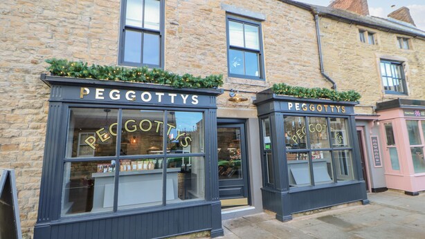 A building with two storefronts labeled "PEGGOTTS". - Elm Cottage (Bishop Auckland)