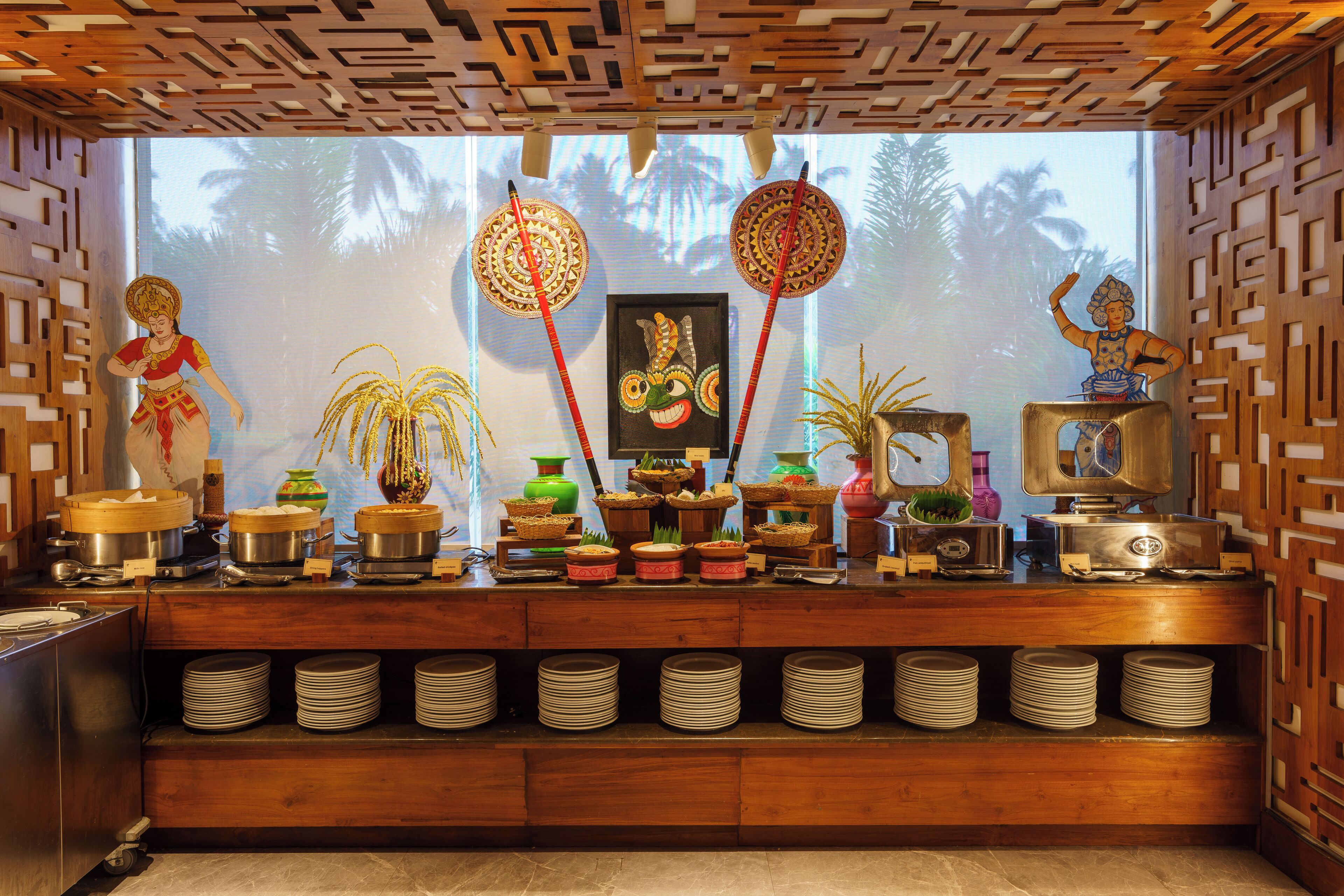 A kitchen with a wooden counter, various kitchen utensils, and decorative items.