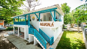 A two-story building with a sign reading "Aguasalá". - Aguasalá Beach House, Puerto Nuevo Beach (Vega Baja)