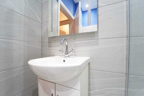 Apartment, 1 King Bed with Sofa bed | Bathroom | Shower, hair dryer, towels