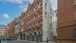 Un bâtiment historique doté d’arcs en plein cintre et d’une façade en briques.