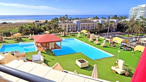A resort with multiple swimming pools, a beach view, and palm trees. - Apartment BUENA VISTA (Palm Garden) Morro Jable, sea view, pool (Morro Jable)