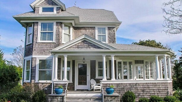 A two-story house with a covered porch and a front door. - Charming home in downtown Chatham (Chatham)