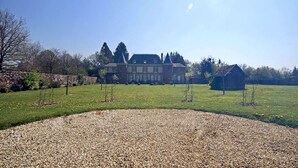 A large, two-story house with a symmetrical facade, a well-maintained lawn, and a gravel driveway leading to the entrance. - The Château Orangerie (Hugleville-En-Caux)