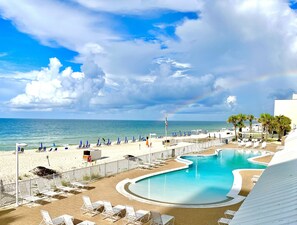 A resort with a pool, beach area, and ocean view.