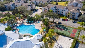 A residential complex with multiple apartment buildings, a swimming pool, and a basketball court. - Resort 5 Bed Private Pool & Spa, Game Room Home 5 Bedroom Villa by RedAwning (Kissimmee)