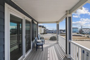 Enjoy the serene neighborhood view from this cozy porch with a pair of comfortable chairs.