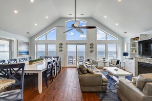 Enjoy a spacious room with a dining area, seating area, and large windows offering a view of the outdoors.